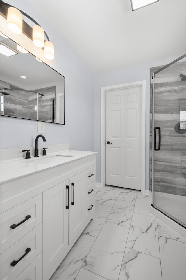 bathroom with a shower with door and vanity