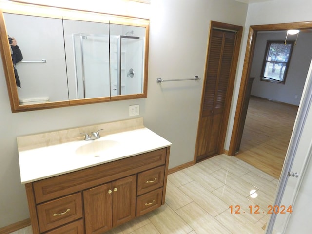 bathroom featuring vanity, an enclosed shower, and toilet