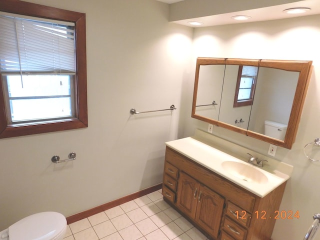 bathroom with vanity, toilet, and tile patterned flooring