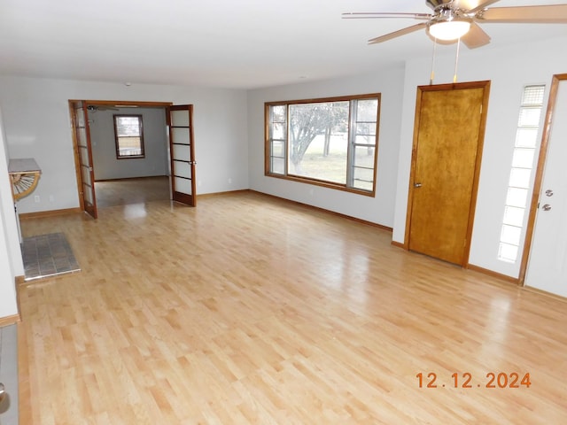 unfurnished living room with ceiling fan and light hardwood / wood-style floors