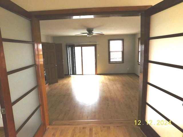 empty room featuring wood-type flooring and ceiling fan