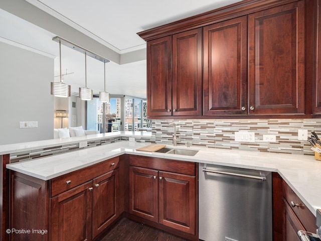 kitchen featuring stainless steel dishwasher, kitchen peninsula, ornamental molding, and pendant lighting