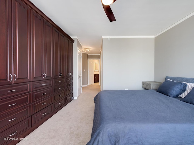 carpeted bedroom featuring ceiling fan, crown molding, and a closet