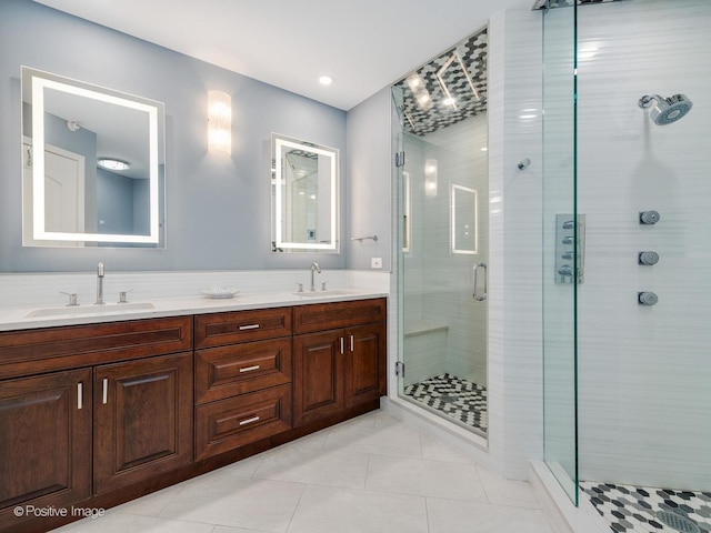 bathroom featuring tile patterned floors, walk in shower, and vanity