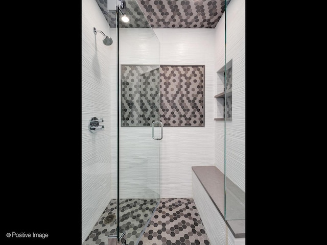 bathroom with a shower with shower door