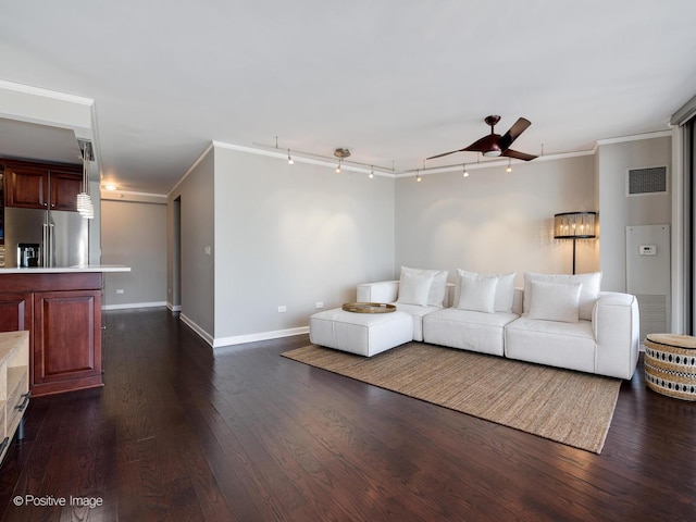 living room featuring ceiling fan, ornamental molding, track lighting, and dark hardwood / wood-style floors