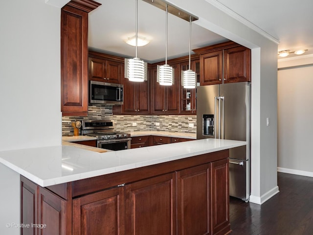 kitchen with light stone countertops, appliances with stainless steel finishes, kitchen peninsula, and tasteful backsplash