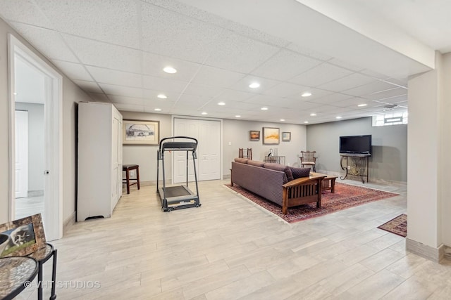 interior space with a drop ceiling and light hardwood / wood-style flooring