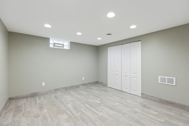 basement with light hardwood / wood-style floors