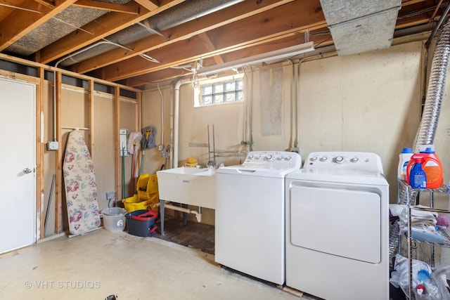 clothes washing area with sink and washing machine and clothes dryer