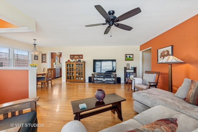 living room with ceiling fan and light hardwood / wood-style flooring