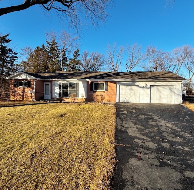 ranch-style home with a front yard and a garage