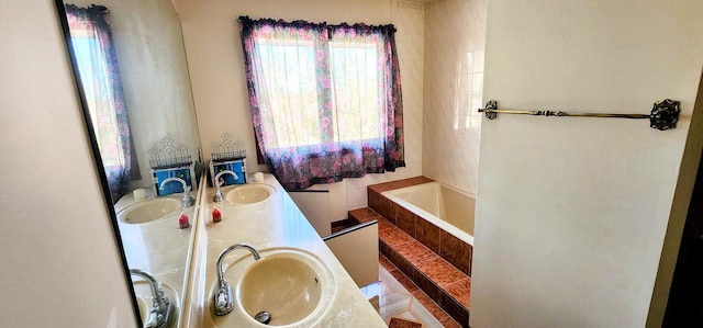 bathroom with vanity and a relaxing tiled tub