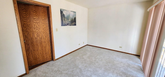 unfurnished bedroom featuring light carpet