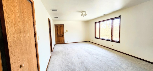 unfurnished bedroom with a closet and light colored carpet