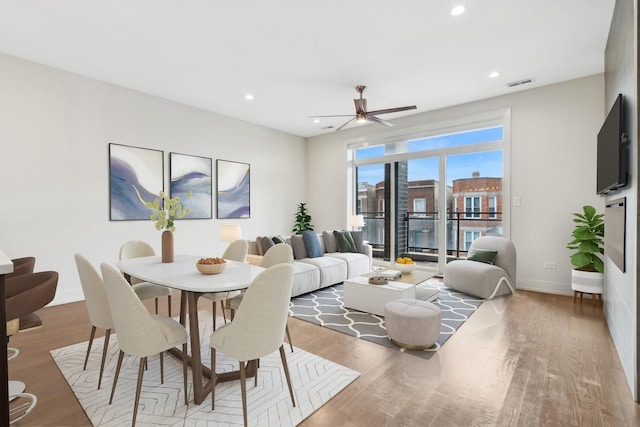 dining room with ceiling fan and light hardwood / wood-style flooring