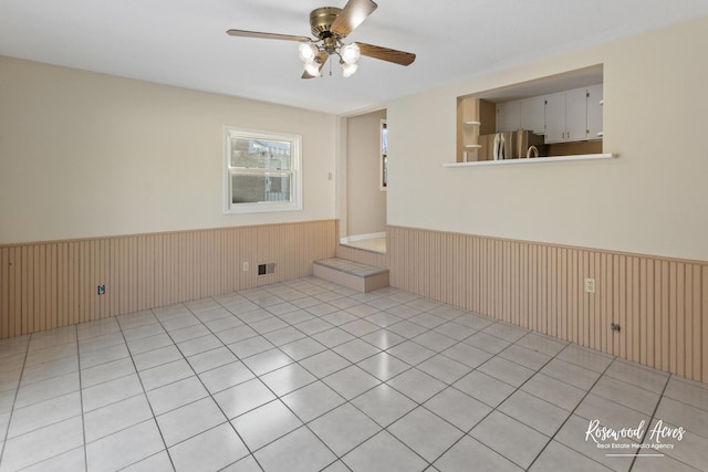 unfurnished room featuring ceiling fan and light tile patterned flooring