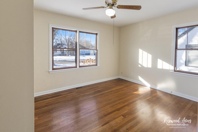 unfurnished room featuring ceiling fan and dark hardwood / wood-style floors