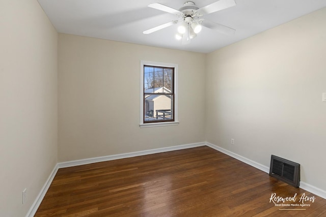 spare room featuring ceiling fan and dark wood-type flooring