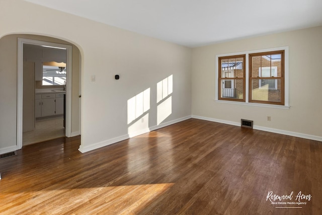 unfurnished room featuring dark hardwood / wood-style flooring