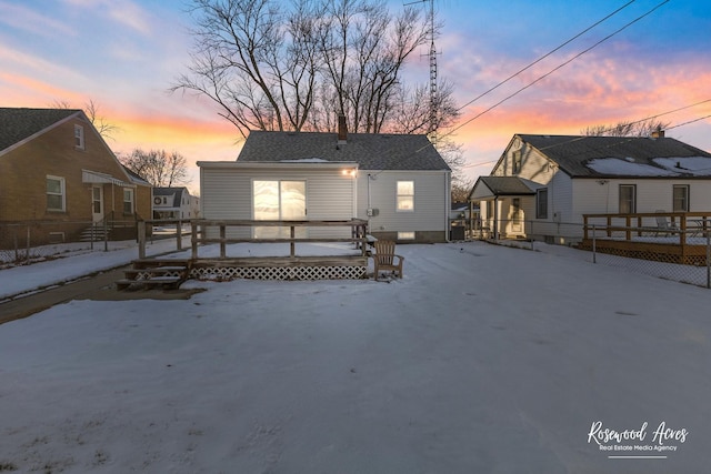 snow covered property with a wooden deck