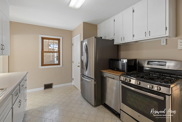 kitchen featuring white cabinetry and appliances with stainless steel finishes