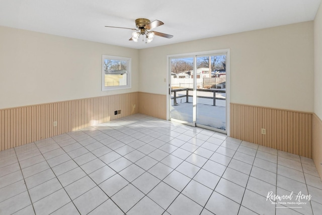 unfurnished room featuring ceiling fan and light tile patterned flooring