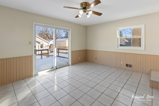 empty room featuring ceiling fan and light tile patterned floors