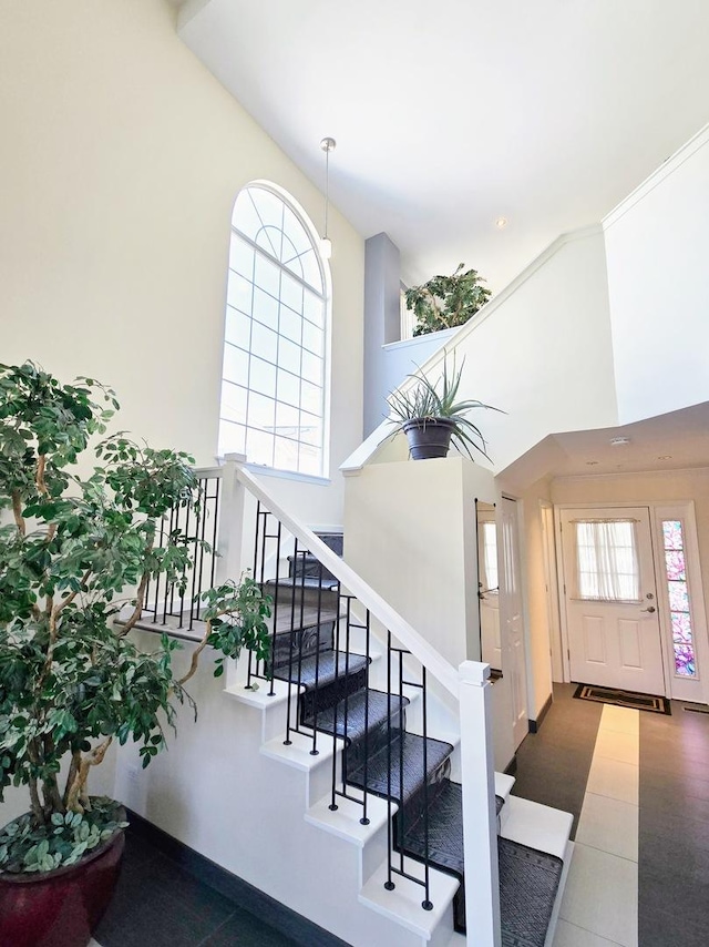 staircase with a towering ceiling