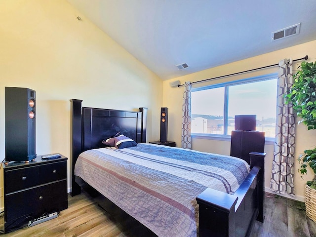 bedroom featuring lofted ceiling and hardwood / wood-style floors