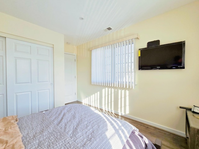 bedroom featuring wood-type flooring and a closet