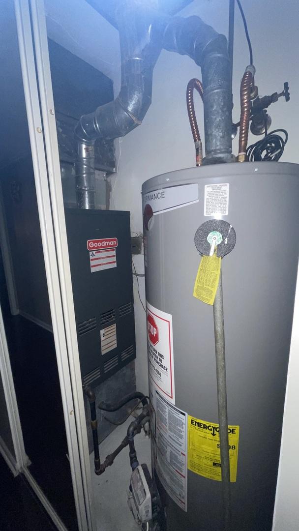 utility room with gas water heater