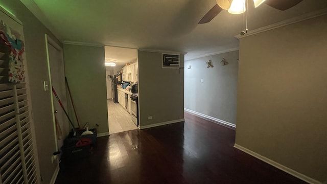 interior space with crown molding, baseboards, ceiling fan, and wood finished floors