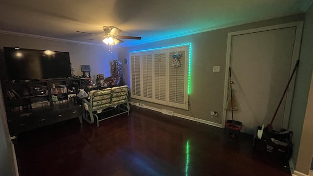 interior space with ornamental molding, a ceiling fan, and baseboards