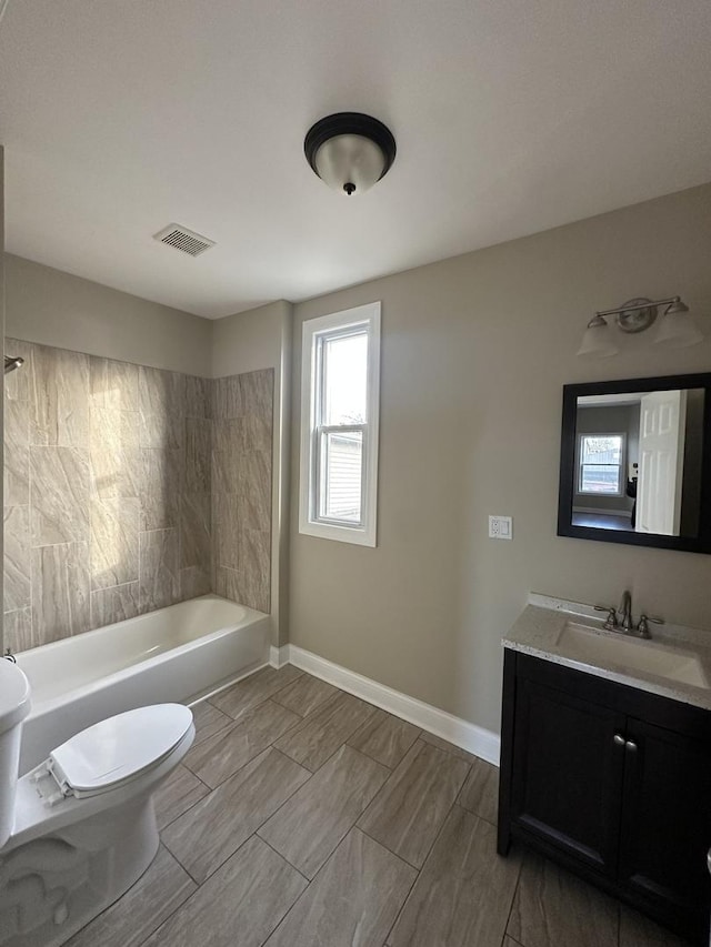 full bathroom featuring bathtub / shower combination, vanity, and toilet