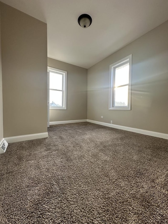 spare room with carpet and a healthy amount of sunlight