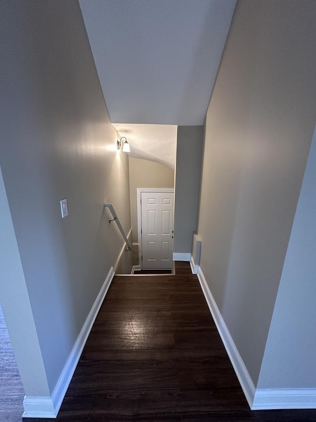 stairs featuring lofted ceiling and wood-type flooring