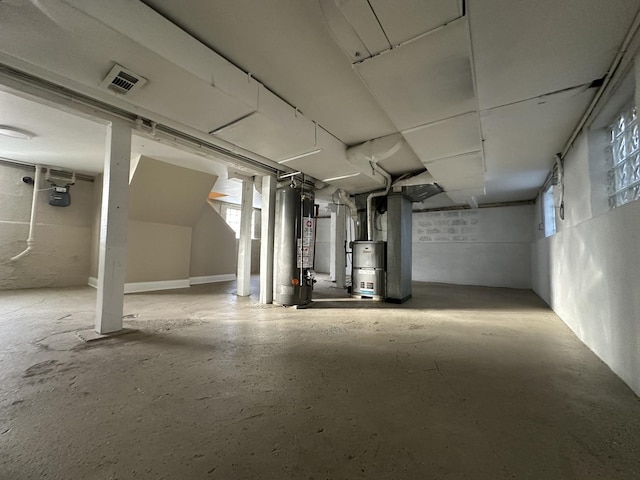 basement featuring water heater and plenty of natural light