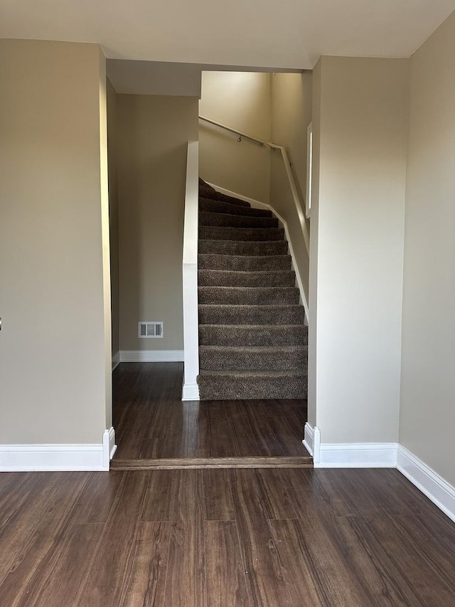 stairway with hardwood / wood-style floors