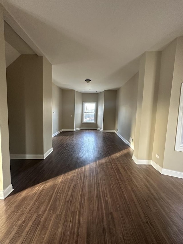 unfurnished room featuring dark wood-type flooring