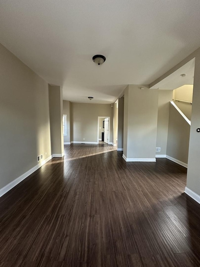 unfurnished room with dark hardwood / wood-style flooring