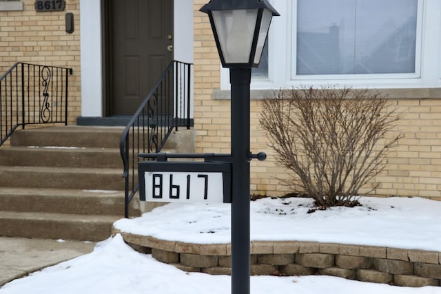 view of snow covered property entrance