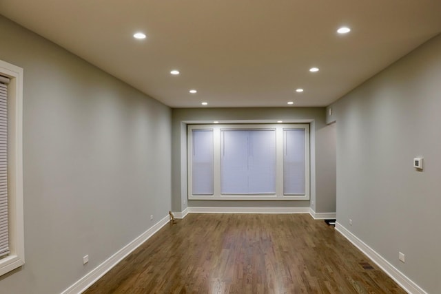 empty room with dark hardwood / wood-style flooring