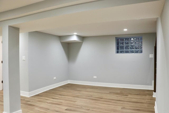 basement with light hardwood / wood-style flooring