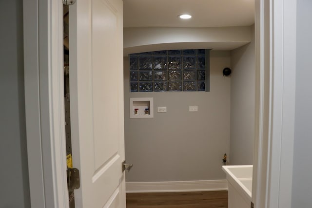 laundry room with dark hardwood / wood-style floors and washer hookup