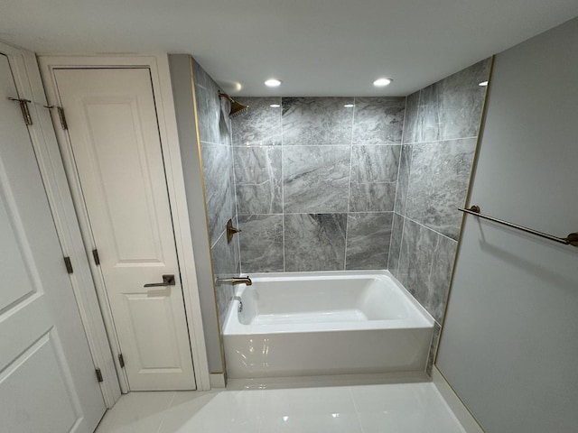 bathroom featuring tile patterned flooring and tiled shower / bath