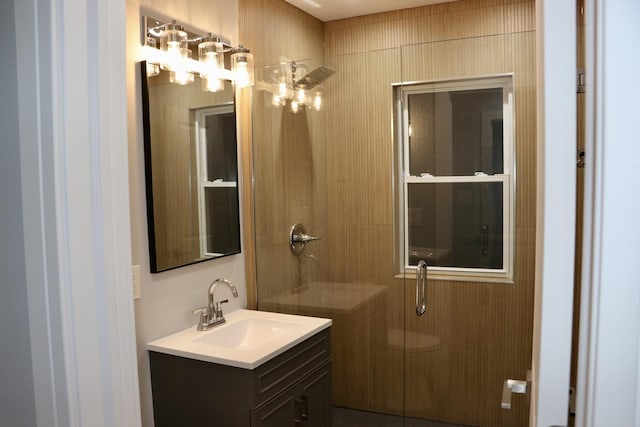 bathroom featuring vanity and a shower with door