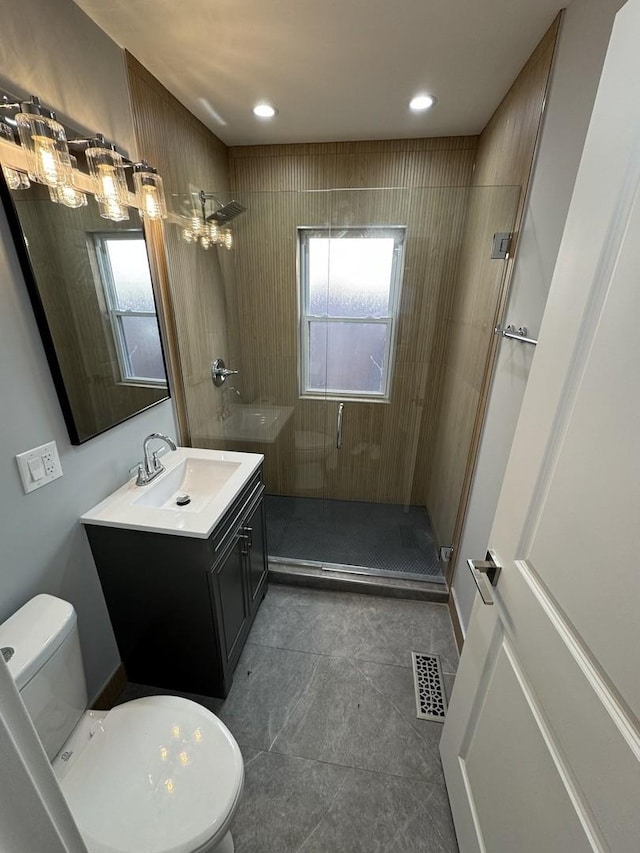 bathroom with vanity, toilet, and an enclosed shower