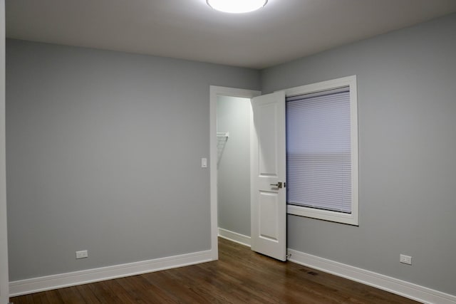 empty room featuring dark hardwood / wood-style flooring