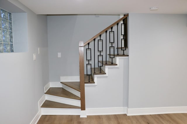 staircase with wood-type flooring